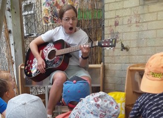 Playing guitar for nursery children